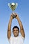 Portrait of attractive tennis player holding his trophy