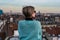 Portrait of an attractive thirty year old white woman with sunglasses posing on her rooftop with the Brussels skyline during