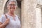 Portrait of attractive traveler senior woman visiting the Cathedral in Barcelona.  Happy retired enjoying vacations and history