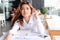 Portrait of attractive young Asian woman with paperwork or charts on the desk in office.