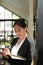 Portrait of attractive young businesswoman writing on a notepad and standind in meeting room.