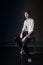 Portrait of attractive young man brunette in wet clothes under droplets of the rain. Studio photo