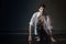 Portrait of attractive young man brunette in wet clothes under droplets of the rain. Studio photo