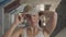 Portrait of attractive young woman putting on military cap on her head and looking in the camera standing in abandoned