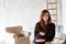 Portrait of an authentic and attractive young woman looking towards the camera and standing in a room