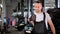 Portrait of auto mechanic showing thumbs up while standing in workshop