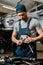 portrait of auto mechanic in uniform with lug wrench