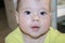 Portrait of baby 8 month old girl boy curious caucasian, close-up face look into camera. Baby beautiful lips first teeth, very