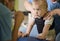 Portrait of a baby with cerebral palsy on physiotherapy in a children therapy center. Boy with disability doing exercises with