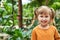 Portrait of a baby girl in the jungle. cheerful child in the zoo