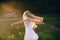 Portrait of a baby girl spinning in a field in sunset light