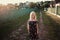 Portrait of a baby girl spinning in a field in sunset light