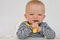 Portrait of baby learning to eat with fork and spoon