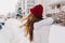 Portrait from back of amazing girl posing with long hair waving in cold winter day. Outdoor photo of dreamy woman in