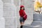 Portrait from back of stylish slim girl in glasses holding leather backpack. Pleased brunette lady in beret looking over