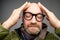 Portrait of bald adult man with beard toching his head with fingers. He is calm and content