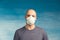 Portrait of a bald man in a respirator