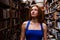 Portrait of ballerina girl in vintage book store wearing casual clothes