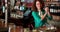 Portrait of barmaid preparing cocktail at bar counter