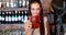 Portrait of barmaid serving cocktail at bar counter