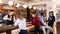 Portrait of barman and people who are standing near bar counter in luxurious restaurant