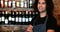 Portrait of barman standing with arms crossed at bar counter