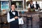 Portrait of bartender holding serving tray with glass of cocktail