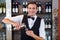 Portrait of bartender pouring tequila into shot glass