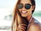 Portrait, beach and woman with sunglasses, vacation and smile with happiness, tropical island and weekend break. Face