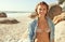 Portrait, beach and woman with sunshine, holiday and getaway trip with freedom and weekend break. Face, person and girl