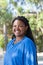 Portrait of beaming African-American woman at park