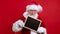 Portrait Beard Santa Claus in Red Suit Looks Into Camera and Holds Black Sign in His Hands With Workspace Area Copy