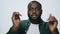 Portrait of bearded african american man dancing on light background.