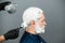 Portrait of bearded man color hair. Process of a man hair coloring at hairdresser salon.