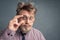 Portrait of a bearded nerd with a disheveled hairstyle, adjusting his glasses