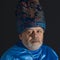 Portrait of bearded senior man in blue oriental clothes