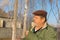 Portrait of a bearded Ukrainian peasant standing under birch tree at fall season