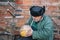 Portrait of a bearded Ukrainian peasant taking pumpkin in the hands and looking at it