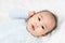 Portrait of a beautiful 4 months newborn smiling, on white background.Cute baby boy smiling