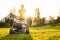 Portrait of beautiful 50s senor woman cutting grass with gasoline lawn mower, gardening