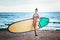 Portrait of beautiful active woman spending summer holidays on the beach, enjoying surfing, Bali, Indonesia