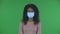 Portrait of beautiful african american young woman in medical mask is looking straight and talking to someone. Burning