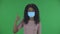 Portrait of beautiful african american young woman in medical protective face mask looking at camera and showing thumbs