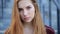 Portrait of beautiful angry sad young girl with long red hair.