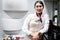 Portrait of beautiful Asian female cabin crew air hostess standing in aircraft kitchen after preparing food and drink to serve