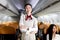 Portrait of beautiful Asian female cabin crew air hostess in uniform standing with arms crossed on aisle inside airplane, woman