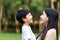 Portrait beautiful Asian Mom and son are laughing at each other in the park, cute and warm