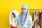 Portrait of beautiful asian muslim woman designer with hijab holding and using smart mobile phone with mockup fake credit card in