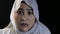 Portrait of beautiful Asian muslim woman wearing hijab shocked worried with mouth opened