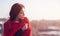 Portrait of a beautiful Asian teen girl in profile, at sunset, with closed eyes in a red scarf